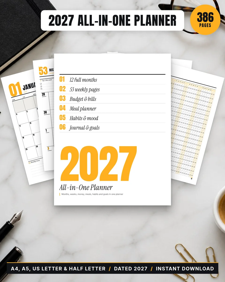 Amber Editorial 2027 planner on marble with a fountain pen