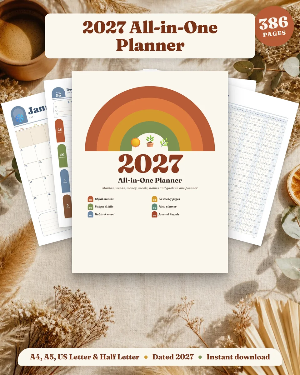 Terracotta Sun 2027 planner with a rainbow cover on linen